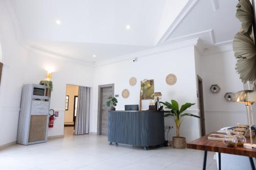 a living room with white walls and a blue cabinet at Le Palais d'Akwa in Abidjan