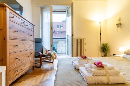 a bedroom with a large bed and a dresser at Varese Centro - ViVa Apartment - Free WiFi in Varese