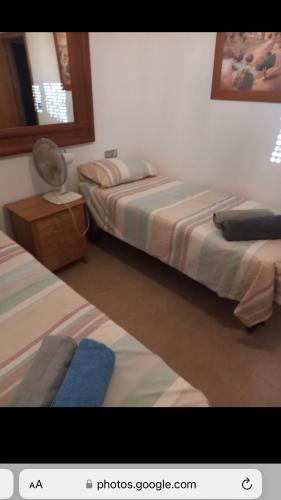 a room with two beds and a mirror at Spanish Villa in Torre del Rame