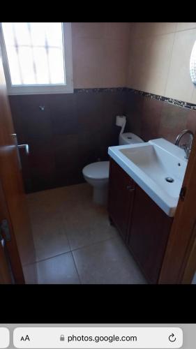 a bathroom with a sink and a toilet and a window at Spanish Villa in Torre del Rame