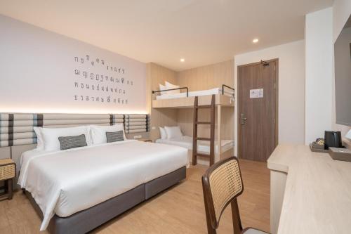 a bedroom with a bed and a bunk bed at Pranakorn Heritage Hotel in Bangkok