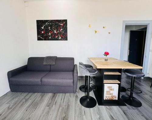 a living room with a couch and a table at Islen in Cognac