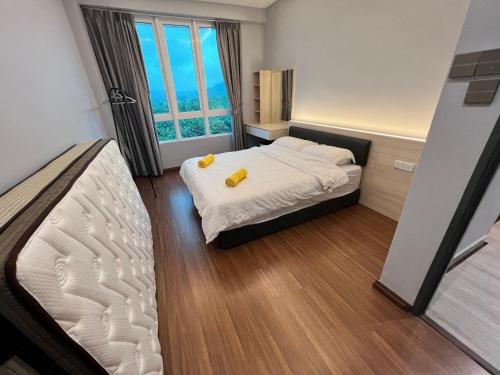 Postel nebo postele na pokoji v ubytování Sri Indah Condominium Sandakan