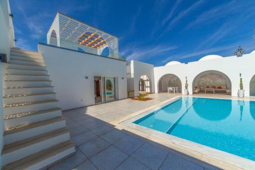 a villa with a swimming pool and stairs at Villa AZUL in Mezraya