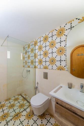 a bathroom with a toilet and a sink and a mirror at Villa AZUL in Mezraya
