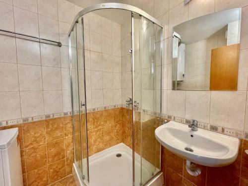 a bathroom with a glass shower and a sink at Arkite - Private apartment - BSR in Sunny Beach