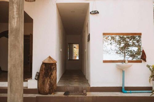 a hallway of a house with a tree stump on the floor at Paradise Sunset Beach in Koh Rong Sanloem