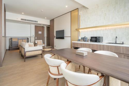 a dining room with a table and chairs at Pranakorn Heritage Hotel in Bangkok