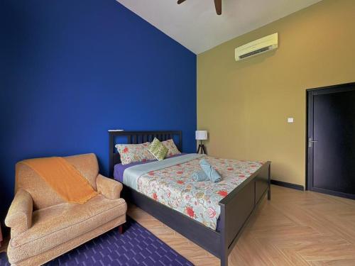 a bedroom with a bed and a chair at Mawarvilla jb in Johor Bahru