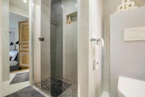 a bathroom with a shower with a glass door at Maison de village romantique in Cagnes-sur-Mer