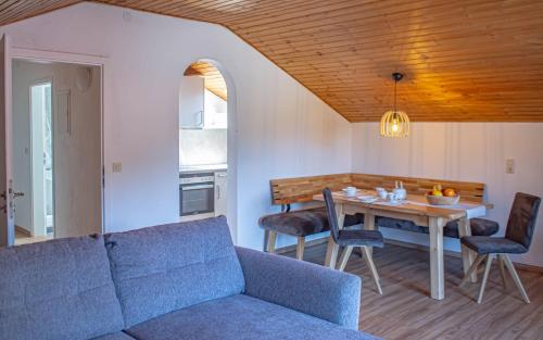 a living room with a couch and a table at Gästehaus Kayetan in Klais