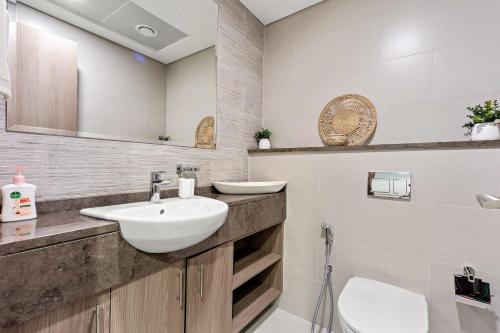 a bathroom with a sink and a toilet at Silkhaus Luxury 1BDR Near NYU Abu Dhabi in Abu Dhabi