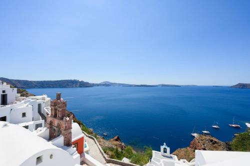 a view of the ocean from the top of buildings at Sophia Oia View in Oia