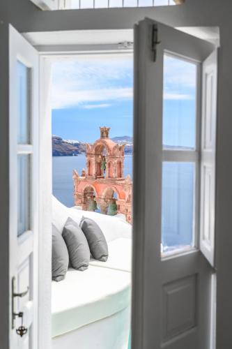 an open door to a room with a view of the ocean at Sophia Oia View in Oia