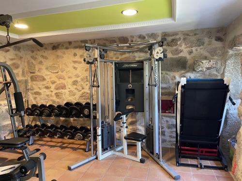 a room with a gym with lots of weights at Chalet casa con piscina en ARBO Vigo in Arbo