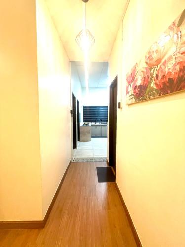 a hallway leading to a room with a painting on the wall at Quayside Cove Homestay - Corner House, Shah Alam Rimbayu Netflix Syok TV BBQ in Shah Alam
