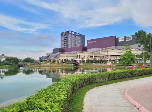 a building with a river in front of it at Quayside Cove Homestay - Corner House, Shah Alam Rimbayu Netflix Syok TV BBQ in Shah Alam