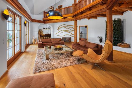 a living room with a couch and a table at Sentio Estate Villa at Lake Balaton in Pécsely