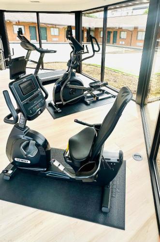 a gym with two exercise bikes and a treadmill at Gadsden Inn and Suites in Gadsden