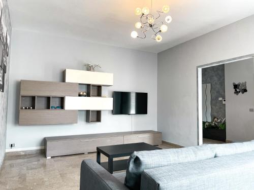 a living room with a couch and a table at Due Pini Apartment - Ponte Caffaro Lake Idro in Ponte Caffaro