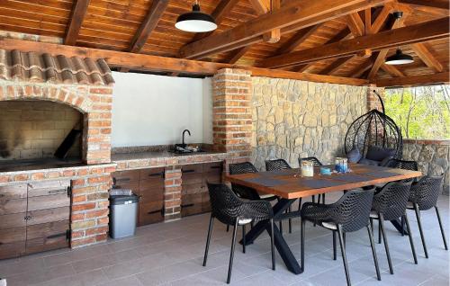 a patio with a table and chairs and a fireplace at 4 Bedroom Stunning Home In Lopar in Lopar