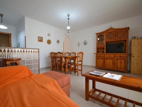 a living room with a couch and a table at Casa Géminis with privat pool in Riumar