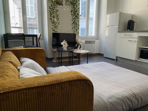 a living room with a large bed and a kitchen at Appartement Cosy Centre ville Marseille wifi in Marseille