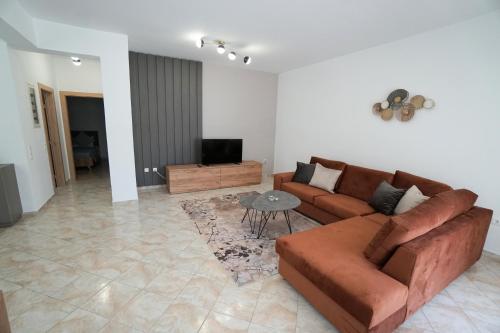 a living room with a couch and a table at Anna's Apartments in Kremasti