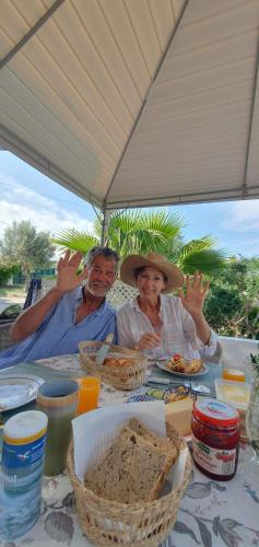 een groep mensen die aan een tafel zitten met eten bij Quinta Alcarias in Santa Catarina da Fonte do Bispo