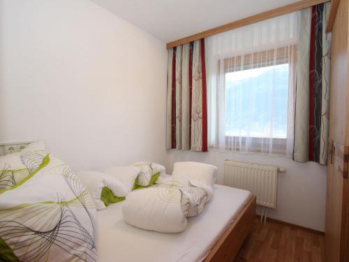 a bedroom with two beds and a window at Apartment Gasteighof-6 by Interhome in Fügen