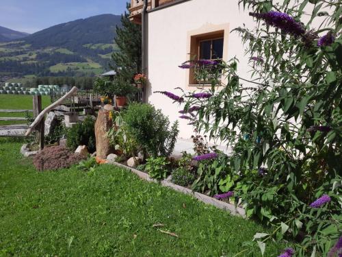 a garden in front of a house with flowers at Apartment Althaus by Interhome in Neukirchen am Großvenediger