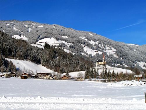 a small village in the snow with a mountain at Apartment Gasteighof-6 by Interhome in Fügen