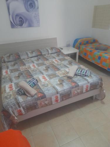 a bed with a quilt on it in a room at Bed and fly Aeroporto Fontanarossa reception h24 in Catania