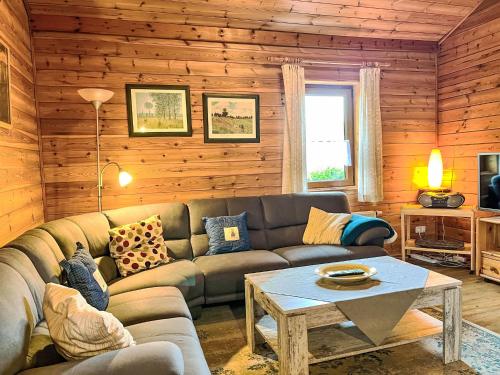 a living room with a couch and a table at Holiday Home Schöne Aussicht by Interhome in Müllenbach