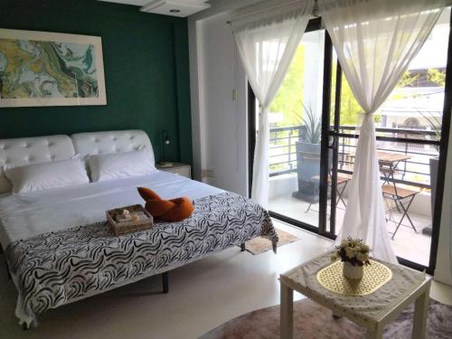 a bedroom with a bed with a vase on it at LarisZone-Luxury Courtyard Villa-Near T1 Free Airport Pick up in Manila