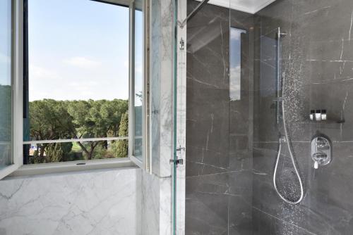 a shower with a glass door and a window at Hotel Splendide Royal - The Leading Hotels of the World in Rome