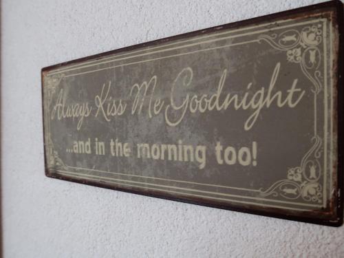 a sign on a wall that reads merry kiss if it be beautiful and in at Apartment Rosablanche E003A by Interhome in Siviez