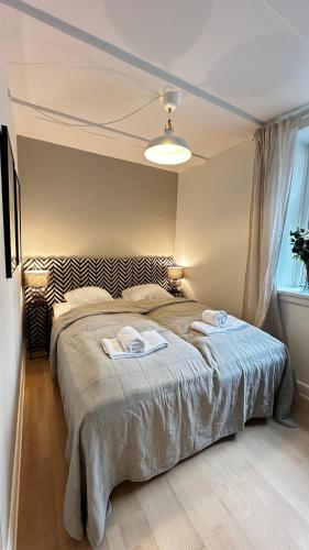 a bedroom with a bed with two towels on it at Løvstræde apartments from 1 to 6 in Copenhagen