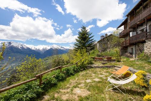 a couple of chairs sitting on the side of a mountain at Agriturismo Les Ecureuils in Saint-Pierre