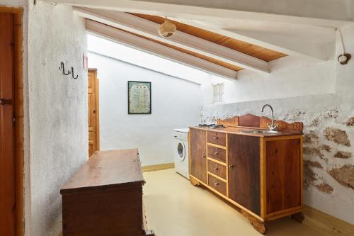 a kitchen with a sink and a washing machine at Cortijo el Soto in Beas de Segura
