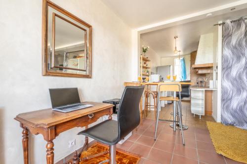a kitchen with a desk with a laptop on it at Le Bohème de Montreuil 13 minutes Paris in Montreuil