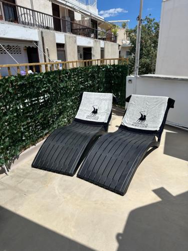 two chairs sitting on top of a patio at Central House in Plaka in Athens