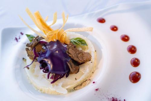 a white plate with a dessert with a crab on it at Hotel Splendide Royal - The Leading Hotels of the World in Rome