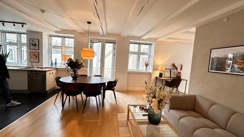 a living room with a table and a couch at Løvstræde apartments from 1 to 6 in Copenhagen