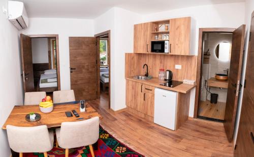a small kitchen and dining room with a table and chairs at Sunrise Apartments - with Old Bridge view in Mostar