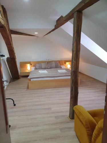 a bedroom with a bed in a room with beams at Apartment U Černého Orla in Karlovy Vary