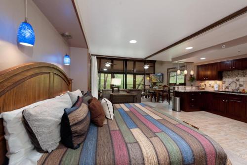 a bedroom with a large bed and a kitchen at Tamarron Gambel Oak 790 - Wild Turkey Ridge - Durango CO in Coffeyville
