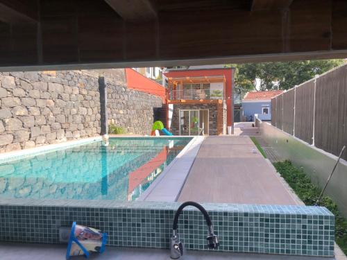 a swimming pool in a building with a swimming pool at HOMELIKE FUNCHAL I in Funchal
