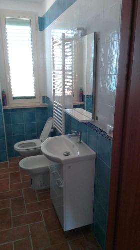 a bathroom with a sink and a toilet and a mirror at Il porto di Iskra in Vasto