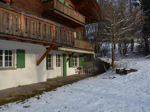 een huis met een terras in de sneeuw bij Apartment Les Erables- Chalet by Interhome in Gstaad